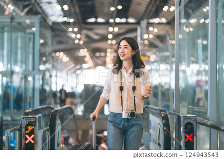 Portrait of standing tourist woman passenger at international airport terminal for holidays travel Portrait of standing tourist woman passenger at international airport terminal for holidays travel 124943543