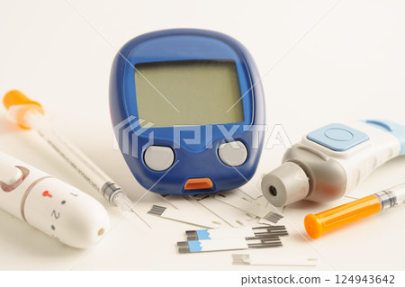 Glucometer lancet and test strips testing blood sugar for diabetes. Glucometer lancet and test strips testing blood sugar for diabetes. 124943642