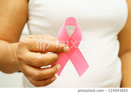 Asian woman with pink ribbon for October world breast cancer day. Asian woman with pink ribbon for October world breast cancer day. 124943683
