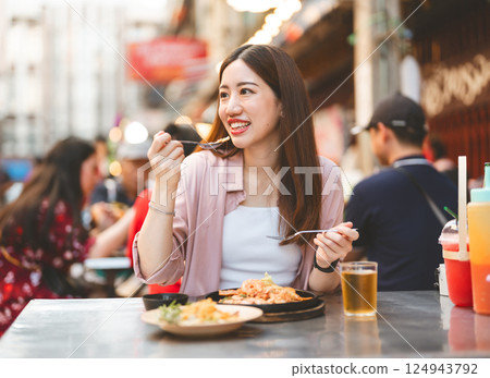 Traveler woman enjoy eating street food spicy menu travel at chinatown Yaowarat, Bangkok, Thailand 124943792
