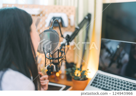 Asian woman composer playing guitar single song with microphone at home studio 124943966