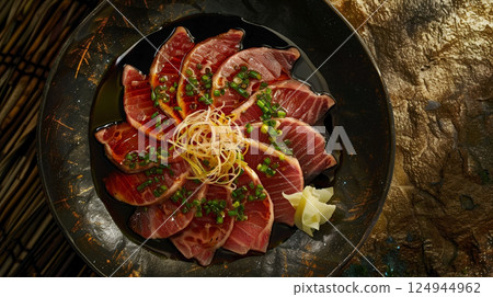 Top-Down View: Tataki-Style Sashimi with Seared Slices, Ponzu Sauce, Ginger, and Garlic Chips 124944962