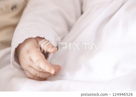 Baptism of a child. A part of the body with little hand in clothes for Baptism 124946526
