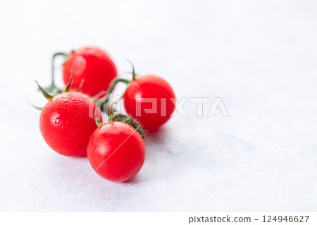 Fresh red cherry tomato on white background. Fresh red cherry tomato on white background. 124946627