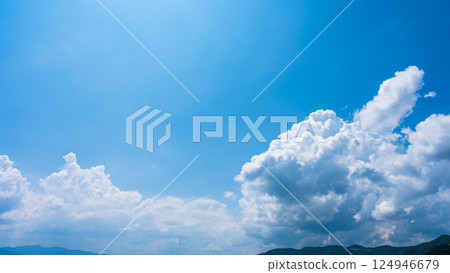 Cumulonimbus clouds over a summer blue sky and mountain scenery Cumulonimbus clouds over a summer blue sky and mountain scenery 124946679
