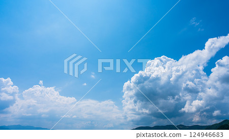 Cumulonimbus clouds over a summer blue sky and mountain scenery Cumulonimbus clouds over a summer blue sky and mountain scenery 124946683