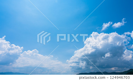 Cumulonimbus clouds over a summer blue sky and mountain scenery Cumulonimbus clouds over a summer blue sky and mountain scenery 124946703