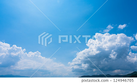 Cumulonimbus clouds over a summer blue sky and mountain scenery 124946705