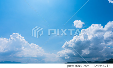Cumulonimbus clouds over a summer blue sky and mountain scenery 124946718