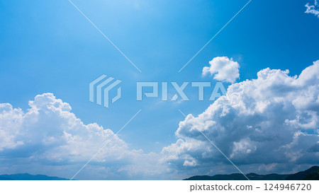 Cumulonimbus clouds over a summer blue sky and mountain scenery 124946720