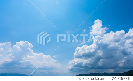 Cumulonimbus clouds over a summer blue sky and mountain scenery Cumulonimbus clouds over a summer blue sky and mountain scenery 124946726