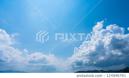 Cumulonimbus clouds over a summer blue sky and mountain scenery 124946761