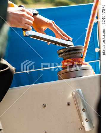 Winch capstan with rope on sailing boat. 124947873
