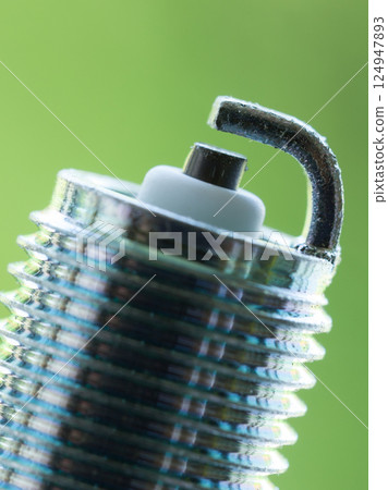 Auto service. New spark plug as spare part of car. Auto service. New spark plug as spare part of car. 124947893