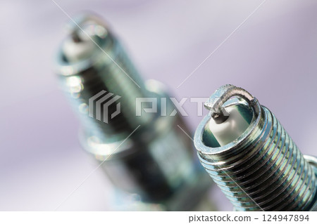 Auto service. Two new spark plugs as spare part of car. Auto service. Two new spark plugs as spare part of car. 124947894