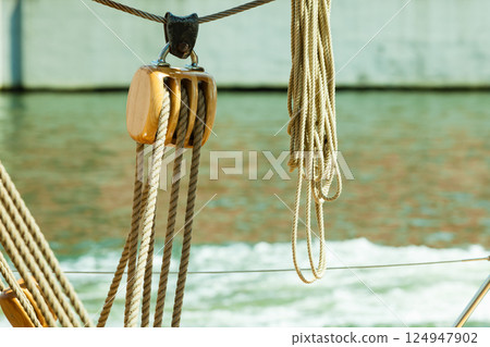 Yachting. Block with rope. Detail of a sailing boat 124947902