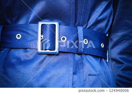 Female fashion. Closeup blue coat wit belt 124948006