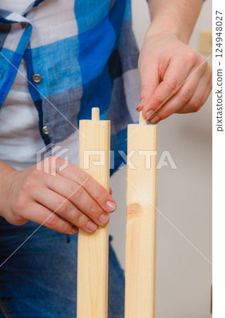 Human assembling wood furniture. DIY. Human assembling wood furniture. DIY. 124948027