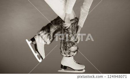 Woman legs wearing ice skates fur socks, skating Woman legs wearing ice skates fur socks, skating 124948071