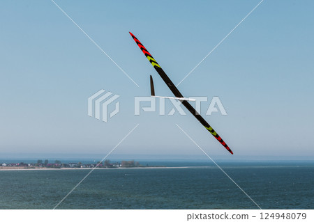 RC soaring plane on blue sky 124948079