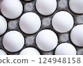 Dozen Fresh White eggs, neatly stacked in Cardboard Tray Top View, create aesthetic Minimalism, Uniformity Purity. Food-related projects, creating corporate identity market decorating kitchen 124948158