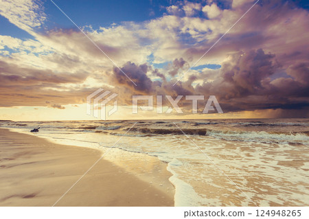 Beatiful sunset with clouds over sea and beach 124948265