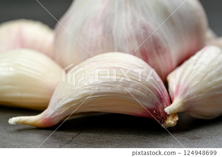 A bag of fresh garlic heads. Purple garlic. Suitable for hot drinks, health, gastronomy, nutritional topics. A bag of fresh garlic heads. Purple garlic. Suitable for hot drinks, health, gastronomy, nutritional topics. 124948699