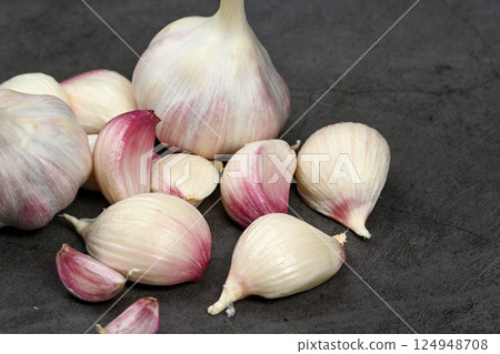 A bag of fresh garlic heads. Purple garlic. Suitable for hot drinks, health, gastronomy, nutritional topics. A bag of fresh garlic heads. Purple garlic. Suitable for hot drinks, health, gastronomy, nutritional topics. 124948708