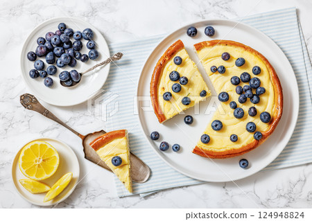 Cheesecake with blueberries sliced on a plate 124948824