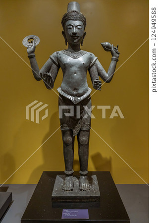 Bronze statue of Hindu god Vishnu with four arms displayed at National Museum Bangkok, Showcasing iconography and mythology in Thai religious art 124949588