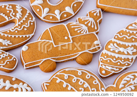 Gingerbread decorated with white sugar glaze. Food background. Christmas cookies. Gingerbread decorated with white sugar glaze. Food background. Christmas cookies. 124950092