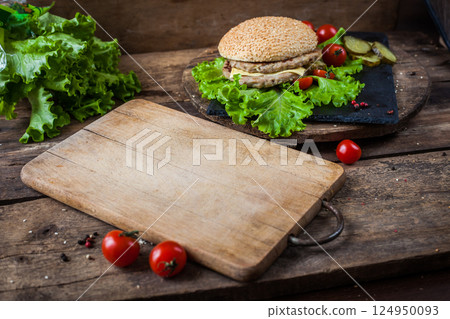 Wooden empty cutting board on the table. Wooden empty cutting board on the table. 124950093