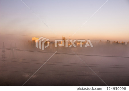 Fog and smog in the city. Power line. Pole wires. Power line top view from the window. Morning in the sleeping area. Fog and smog in the city. Power line. Pole wires. Power line top view from the window. Morning in the sleeping area. 124950096