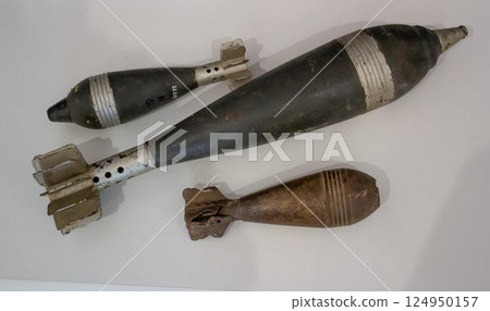 Old military shells and bombs. Severe attillery. A set of weapons. Weapon cartridges. Bomb, projectile, missile from the Second World War, museum piece 124950157