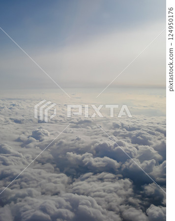 Clouds view from the airplane window. The sky is with cumulus clouds. Beautiful background. Travels. Flying over the cloud. To fly Clouds view from the airplane window. The sky is with cumulus clouds. Beautiful background. Travels. Flying over the cloud. To fly 124950176