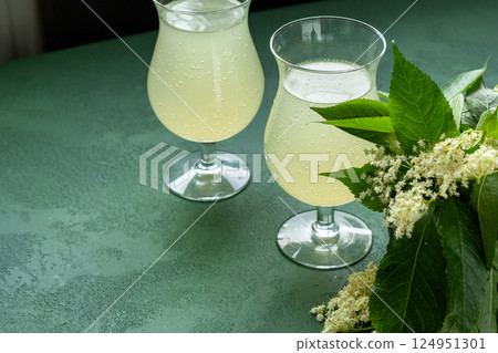 Carbonated elderflower drink. Flower summer kvass in glasses Carbonated elderflower drink. Flower summer kvass in glasses 124951301