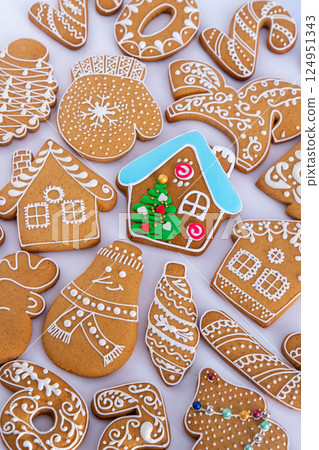 Gingerbread decorated with white sugar glaze. Food background. Christmas cookies. Gingerbread decorated with white sugar glaze. Food background. Christmas cookies. 124951343