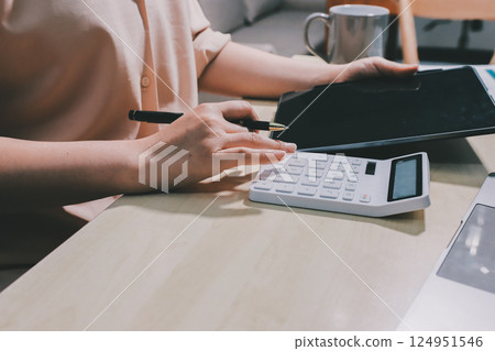 Tax deduction planning concept. Women use a calculator to calculate expenses and taxes to receive tax deductions for personal individual Income. tax return for individual persons.monthly expenses Tax deduction planning concept. Women use a calculator to calculate expenses and taxes to receive tax deductions for personal individual Income. tax return for individual persons.monthly expenses 124951546