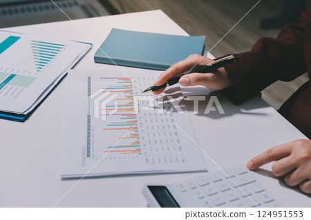 Tax deduction planning concept. Women use a calculator to calculate expenses and taxes to receive tax deductions for personal individual Income. tax return for individual persons.monthly expenses 124951553