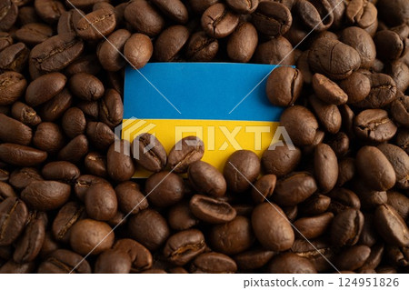 Ukraine flag on coffee beans, shopping online for export or import food product. Ukraine flag on coffee beans, shopping online for export or import food product. 124951826