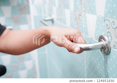 Asian woman patient use toilet support rail in bathroom, handrail safety grab bar, security in nursing hospital. Asian woman patient use toilet support rail in bathroom, handrail safety grab bar, security in nursing hospital. 124951830
