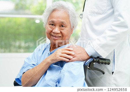 Doctor holding hands Asian elderly woman patient, help and care in hospital. 124952658