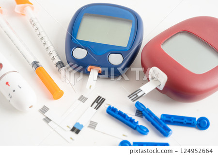 Glucometer lancet and test stick measuring human blood sugar level for diabetes. Glucometer lancet and test stick measuring human blood sugar level for diabetes. 124952664