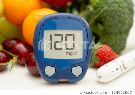 Glucose meter with vegetable and fruit for check sample blood sugar level to treatment diabetes. Glucose meter with vegetable and fruit for check sample blood sugar level to treatment diabetes. 124952667
