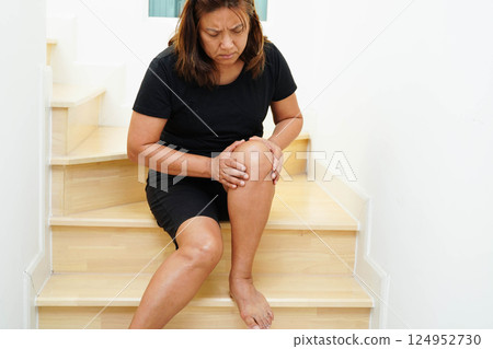 Asian lady woman injury from falling down on slippery surfaces stairs at home. 124952730