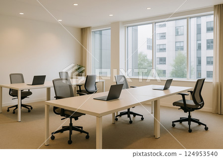 Modern open office space with rows of white desks 124953540