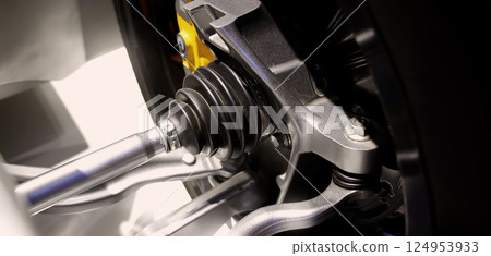 Car suspensions. Close up of a car suspension parts system such as CV joint Rubber boot and Control arms bushing Steering rack axles Shock absorber suspension Brake. Repair and spare parts for cars. Car suspensions. Close up of a car suspension parts system such as CV joint Rubber boot and Control arms bushing Steering rack axles Shock absorber suspension Brake. Repair and spare parts for cars. 124953933