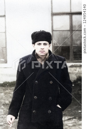 Vintage portrait of attractive young man in cap with cigarette. Retro photo from 1957. Vintage portrait of attractive young man in cap with cigarette. Retro photo from 1957. 124954140