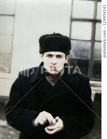 Vintage portrait of attractive young man in hat smoking cigarette. Retro photo from 1957. Vintage portrait of attractive young man in hat smoking cigarette. Retro photo from 1957. 124954141