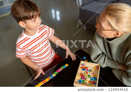 Learning to count at home: adult explains number task to child Learning to count at home: adult explains number task to child 124954410